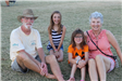 grandparents and grandkids sitting on grass
