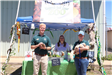 three zoo staff members holding animals