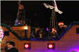 family riding on a float in the parade