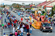 parade floats driving down Highway 59