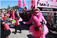 woman in all pink throwing beads