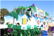 people throwing beads on mardi gras parade float