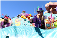 people throwing beads on mardi gras parade float