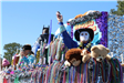 people throwing beads on mardi gras parade float