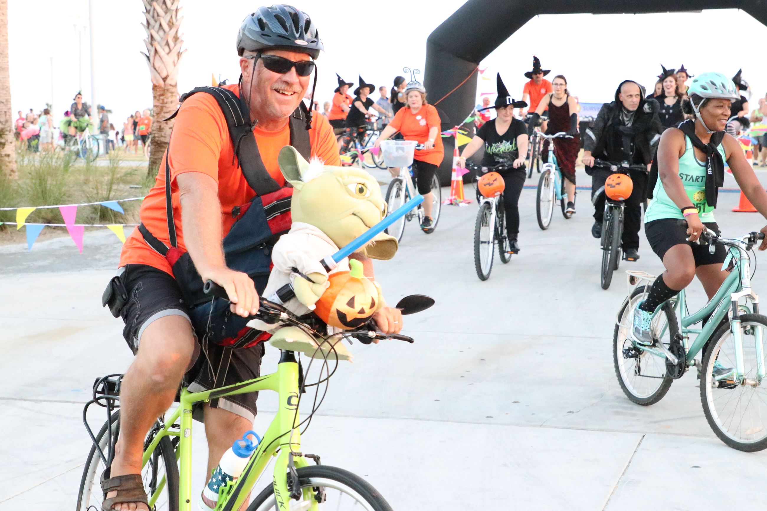 people dressed as witches riding bicycles