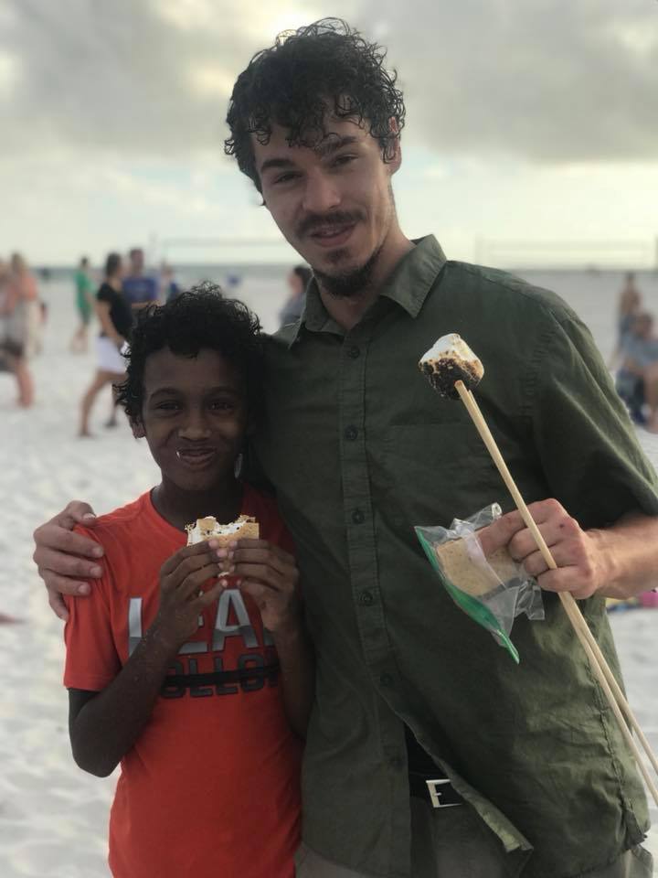 father and son eating smores