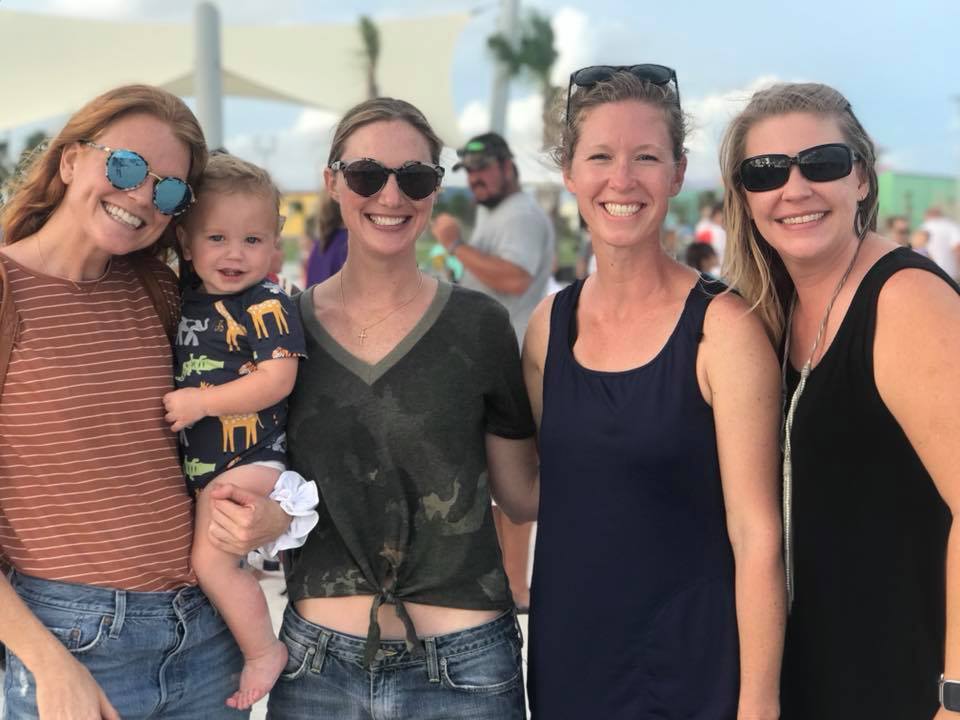 four women and a baby posing for photo