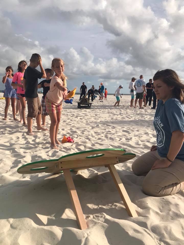 little girl playing cornhole