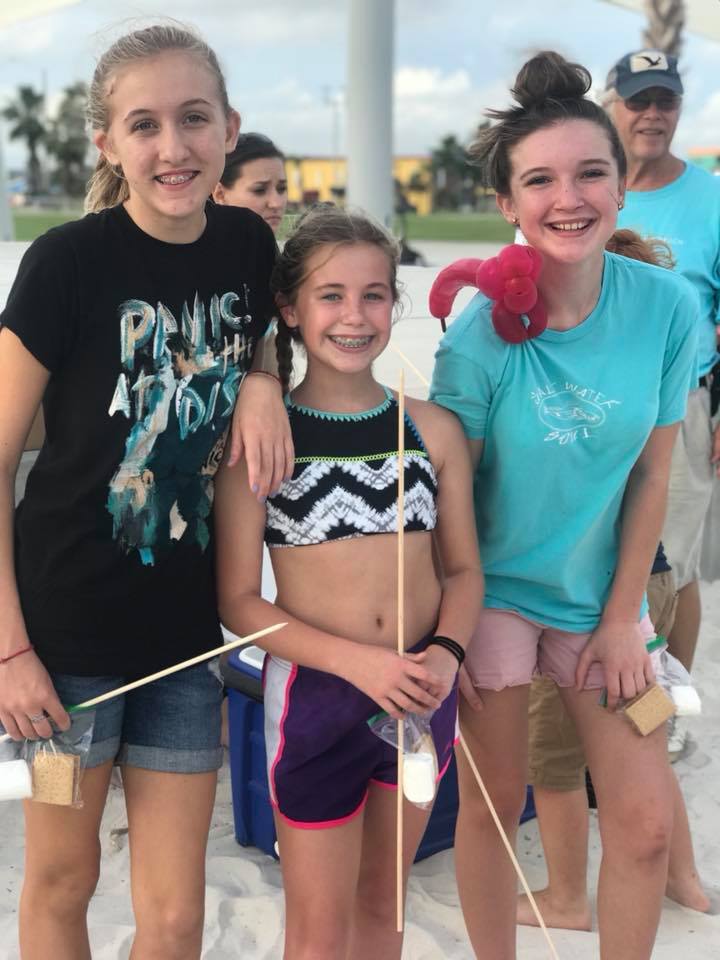 three girls eating smores