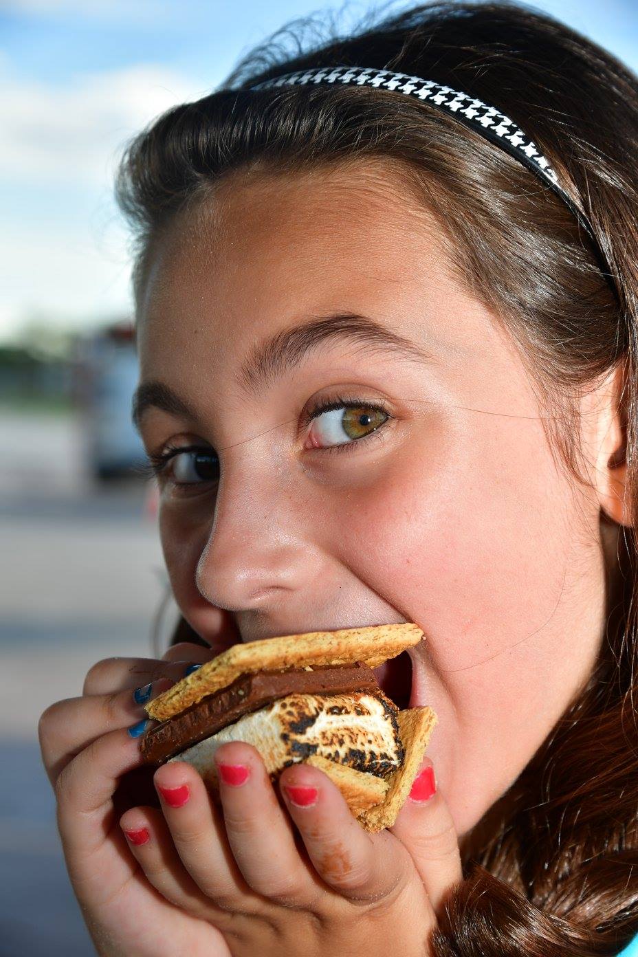 girl eating a smore