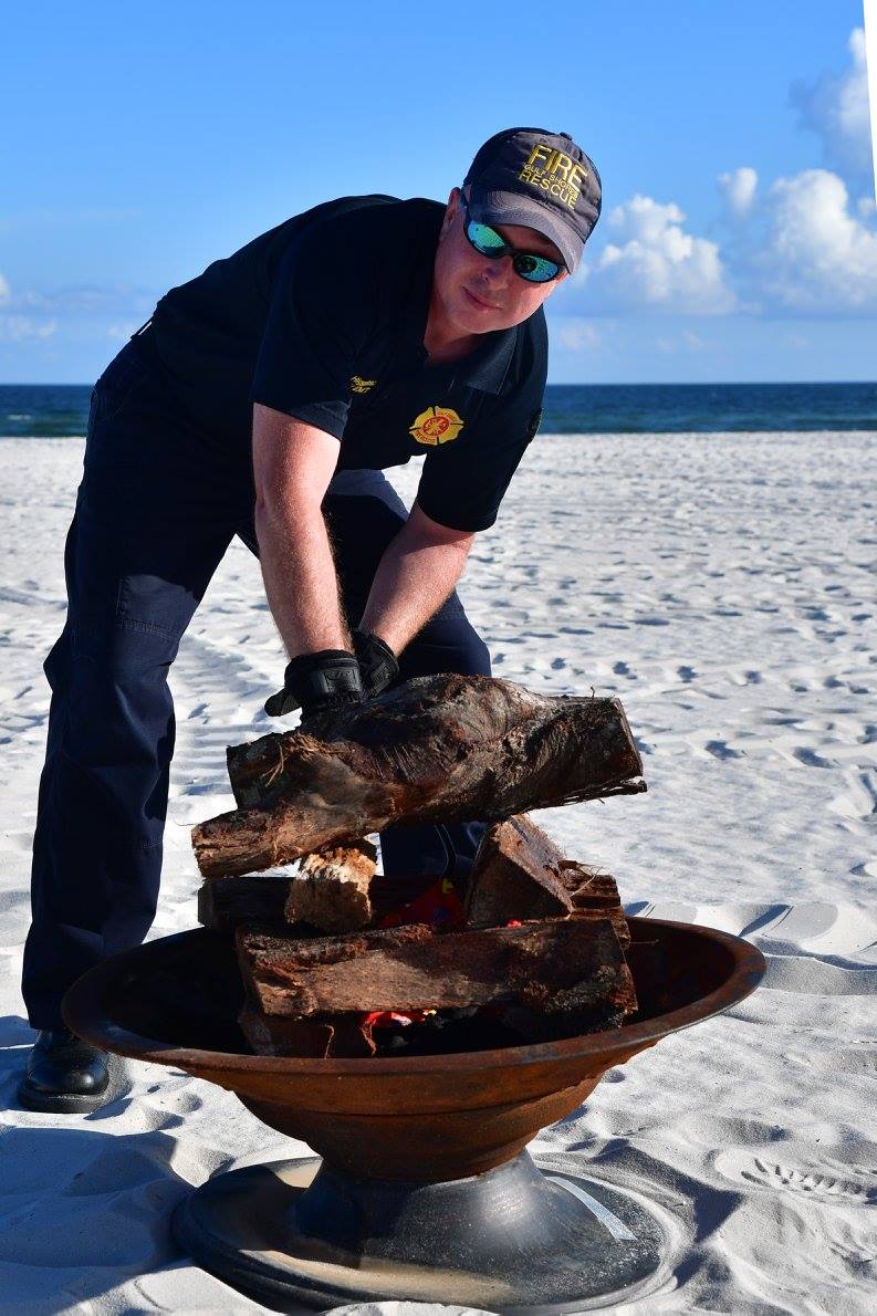 firefighter fixing a fire pit