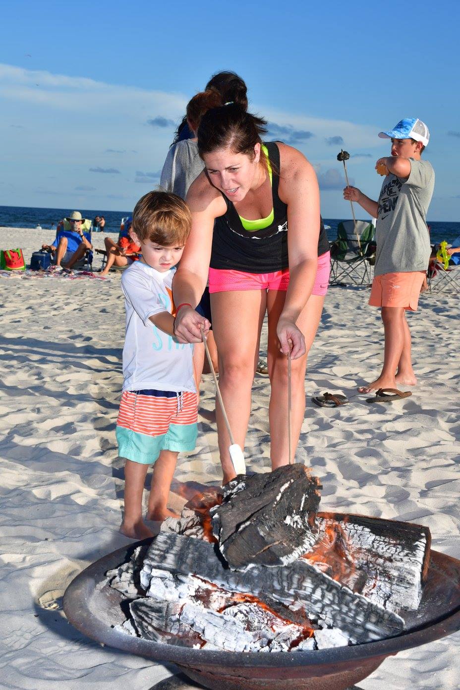mother and son roasting marshmellows