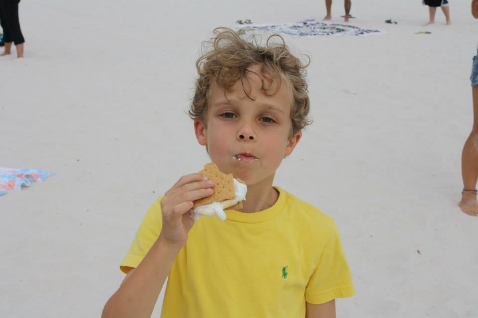 little boy eating a smore