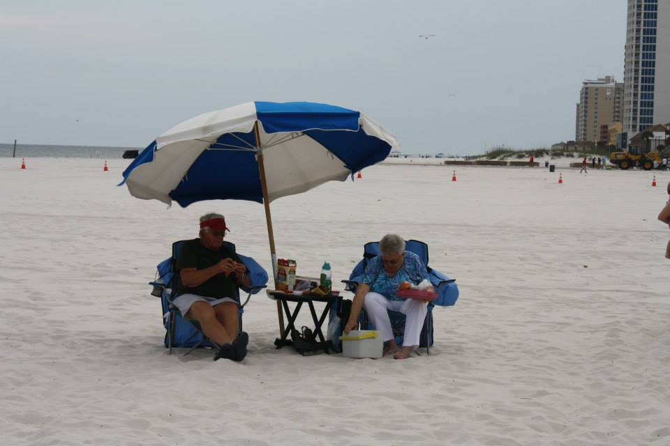 couple sitting under an umbrella