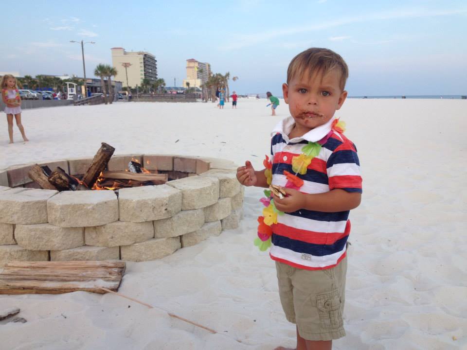 little boy roasting a marshmellow