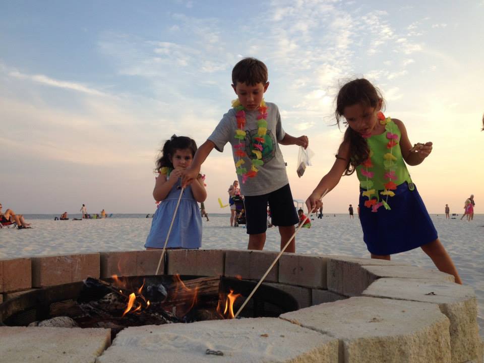 three kids making smores