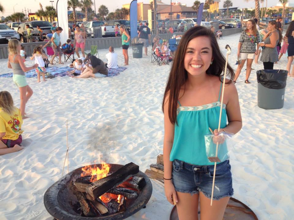 girl smiling for photo with smore