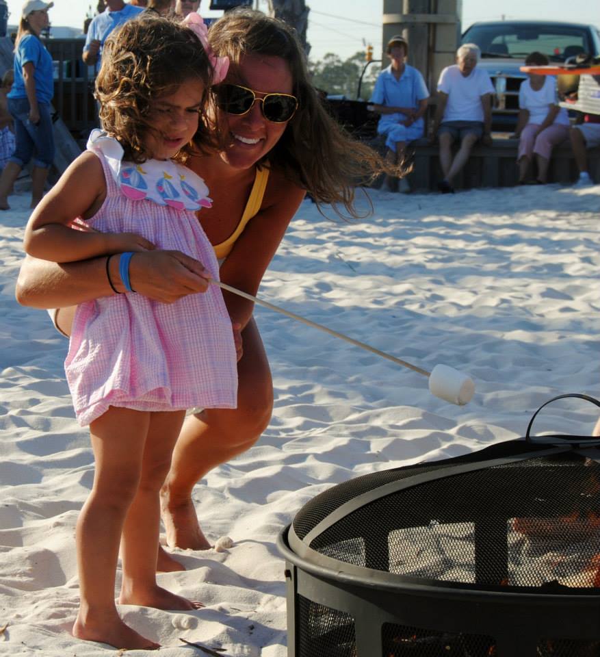 mom and daughter roasting marshmellows