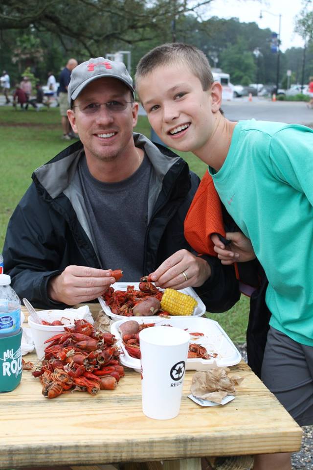 mom and son eating crawfish