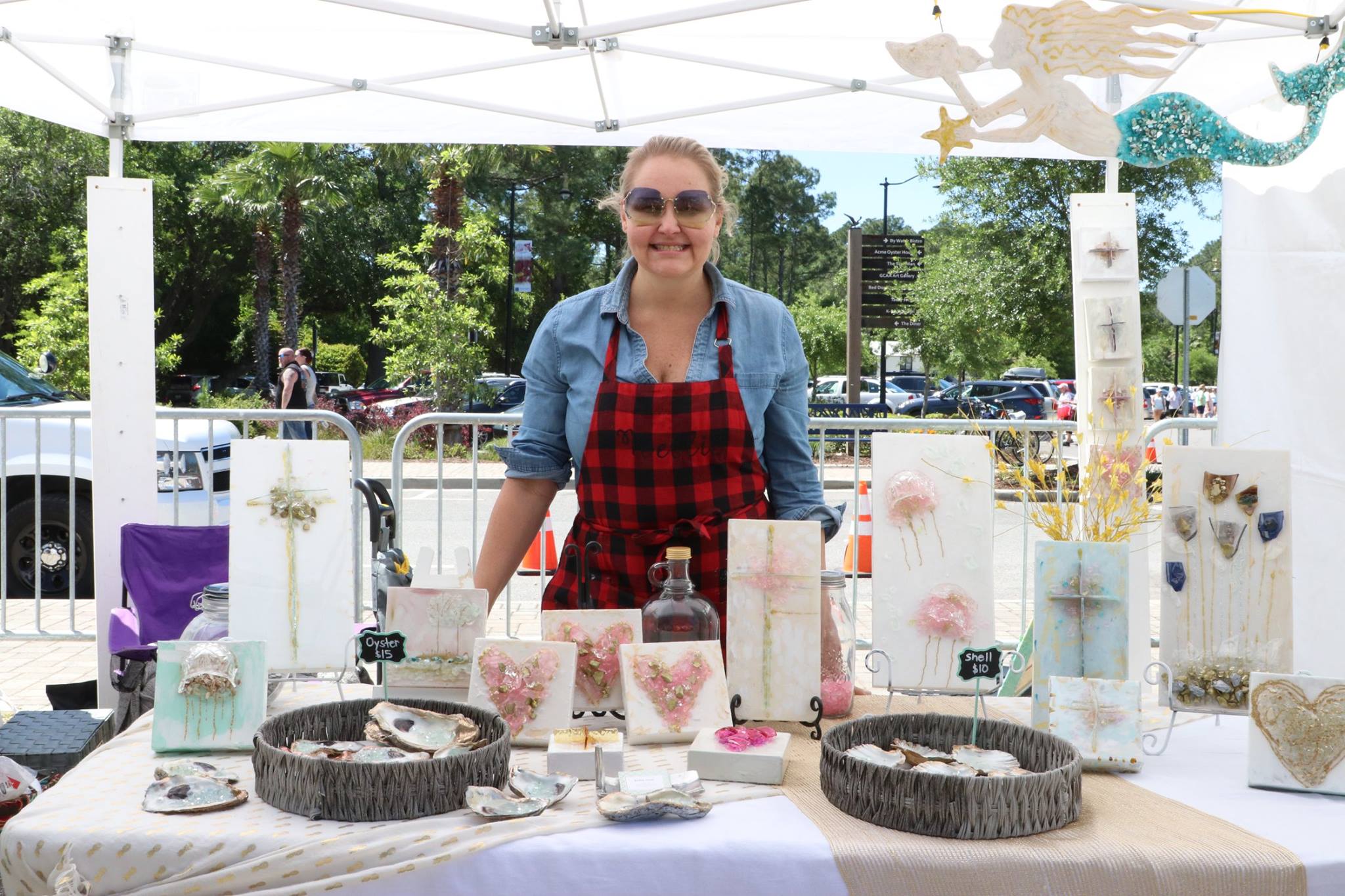 woman standing at her art booth