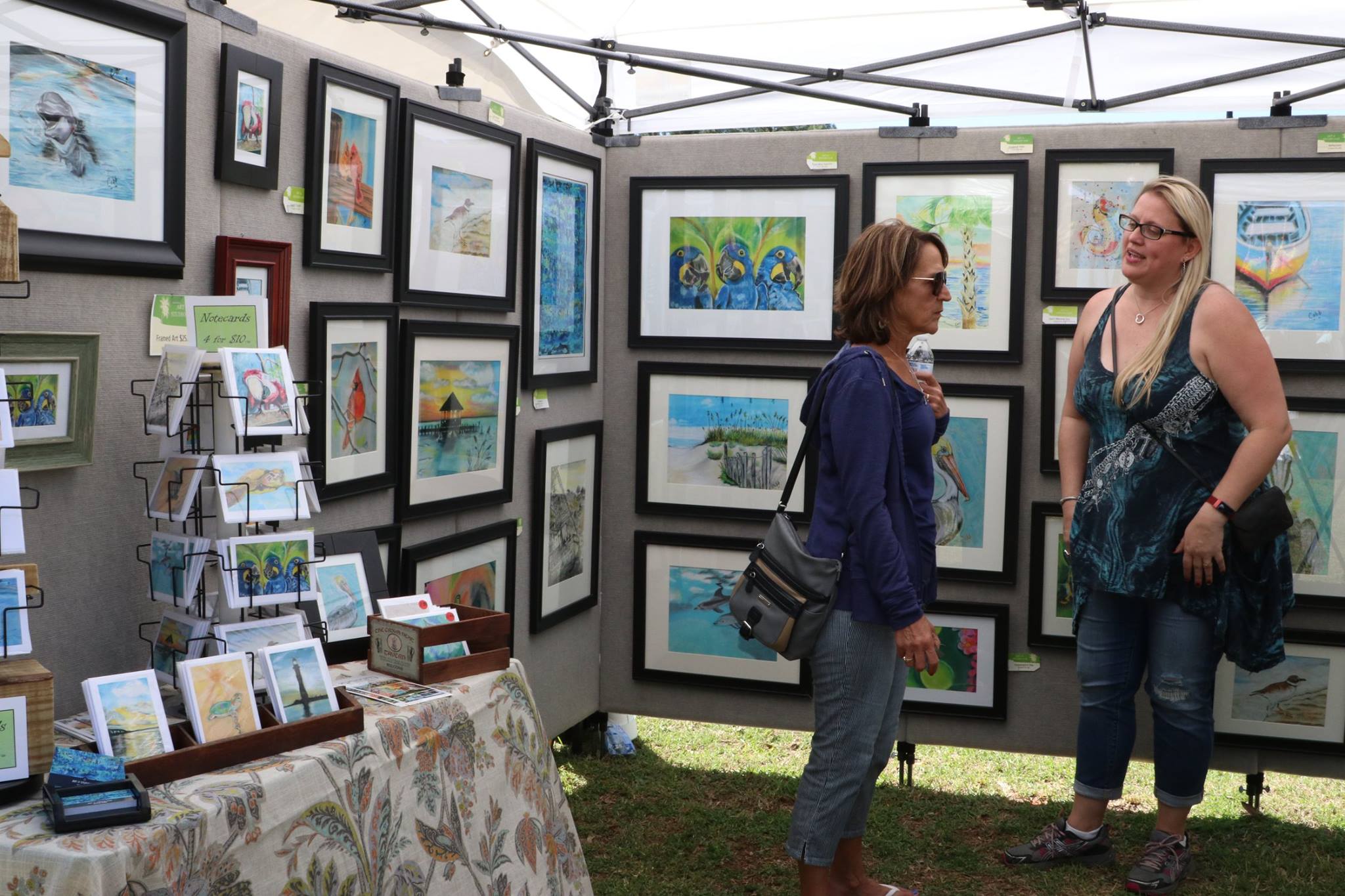 women standing by art talking