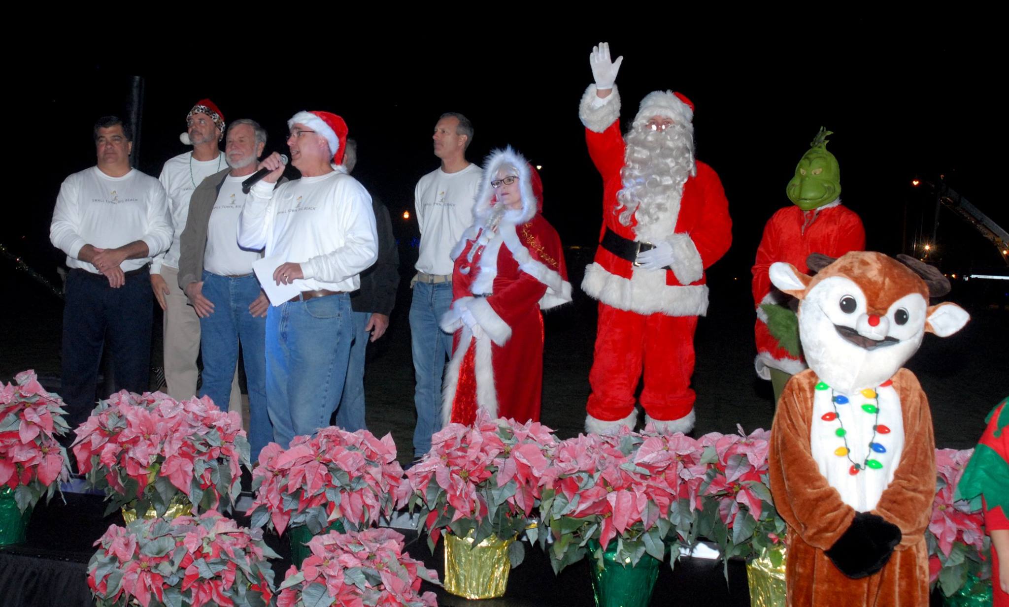 councilmen and santa on stage