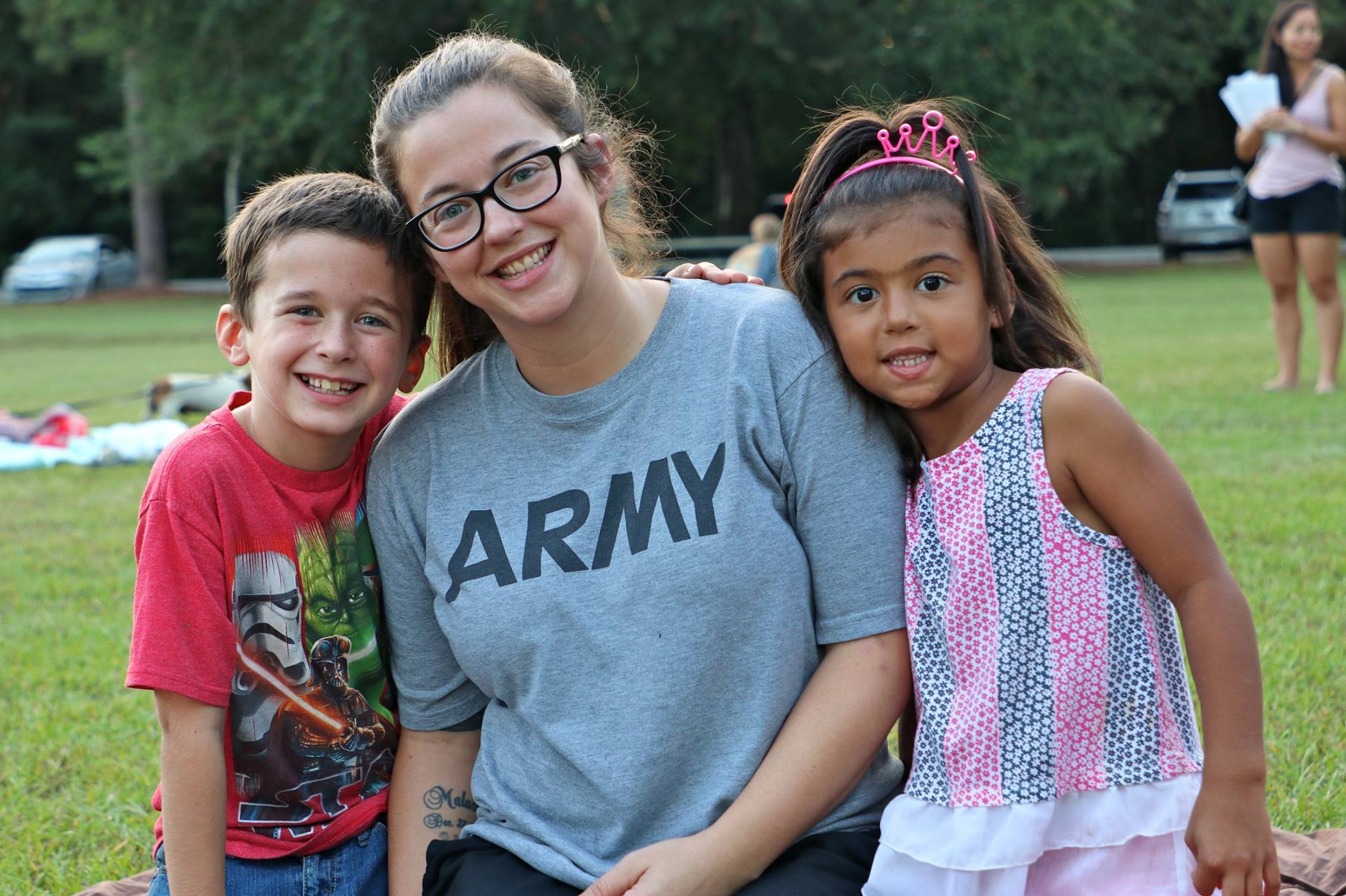 family sitting and smiling while they wait for the movie
