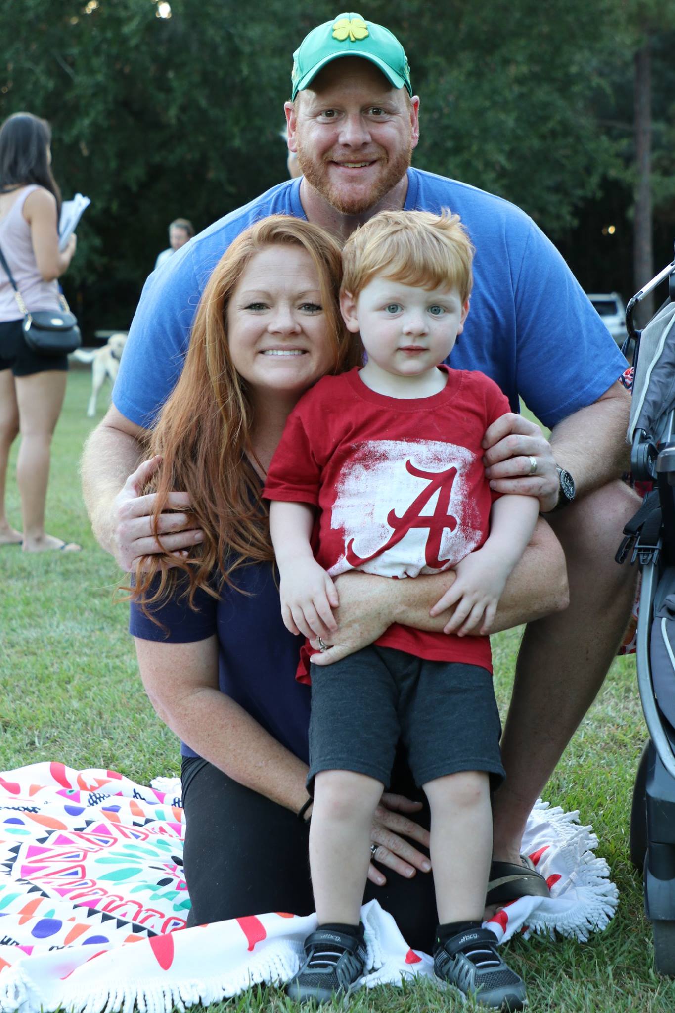 family sitting and smiling while they wait for the movie