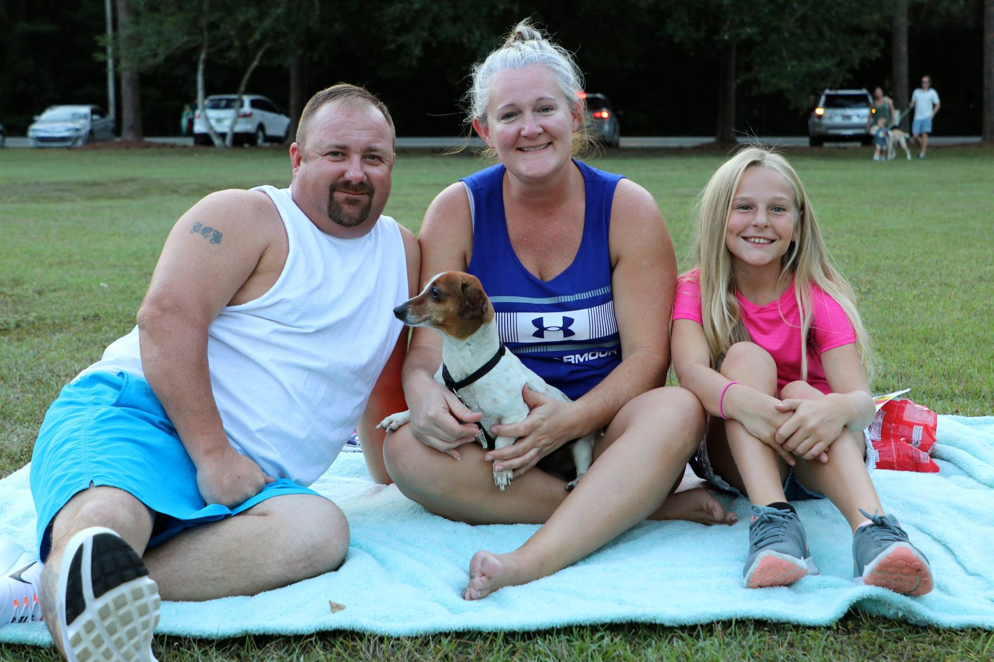 family sitting and smiling while they wait for the movie