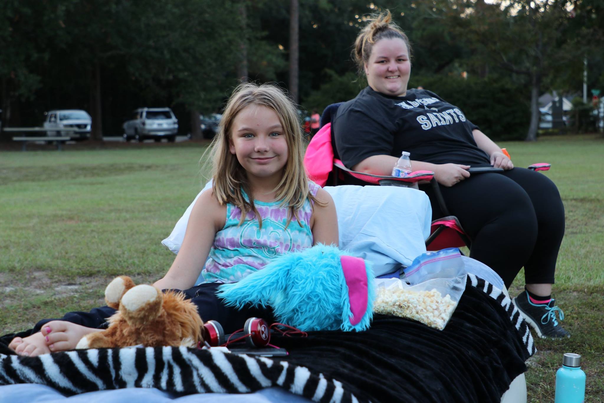 family sitting and smiling while they wait for the movie
