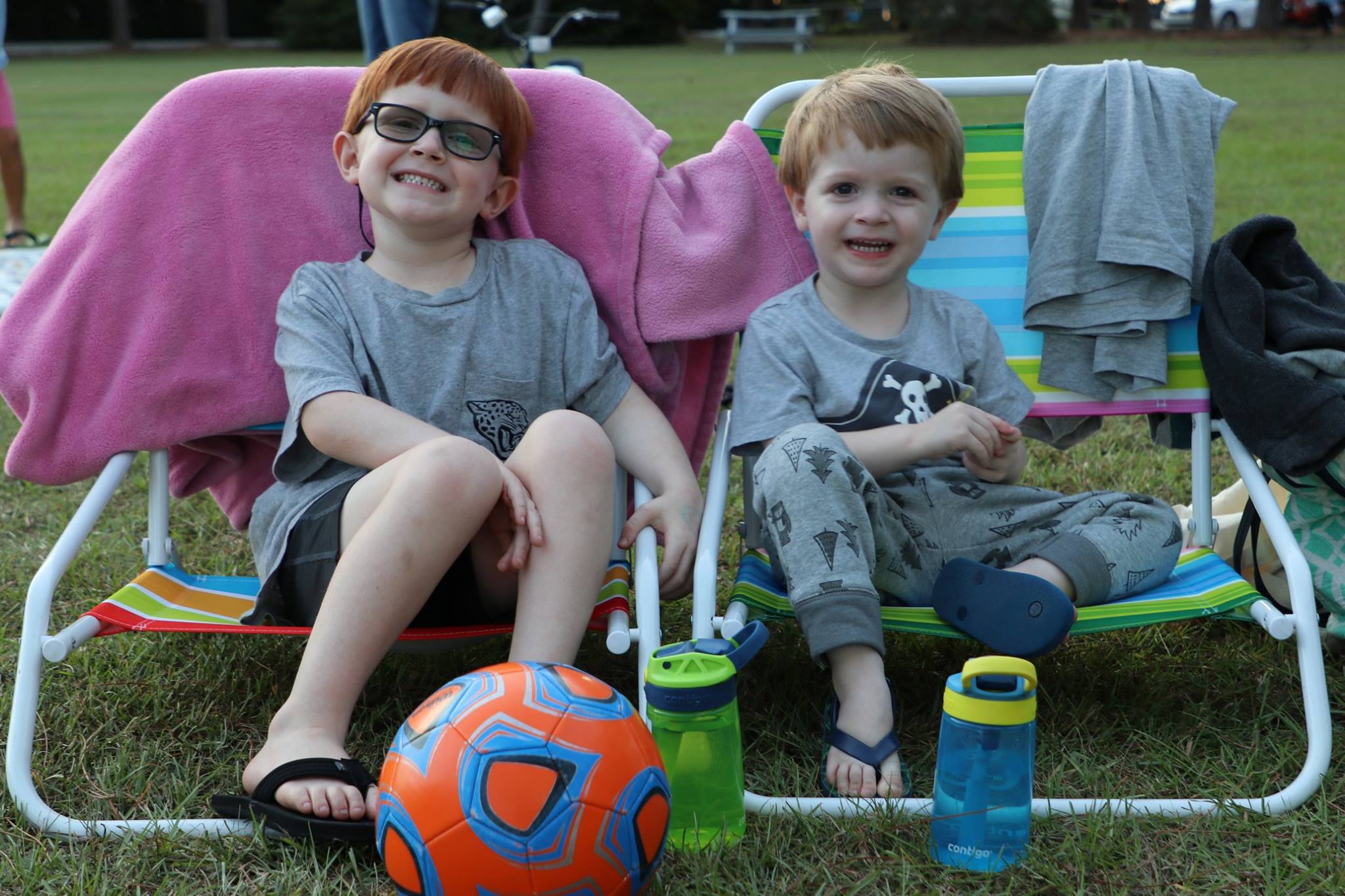 family sitting and smiling while they wait for the movie
