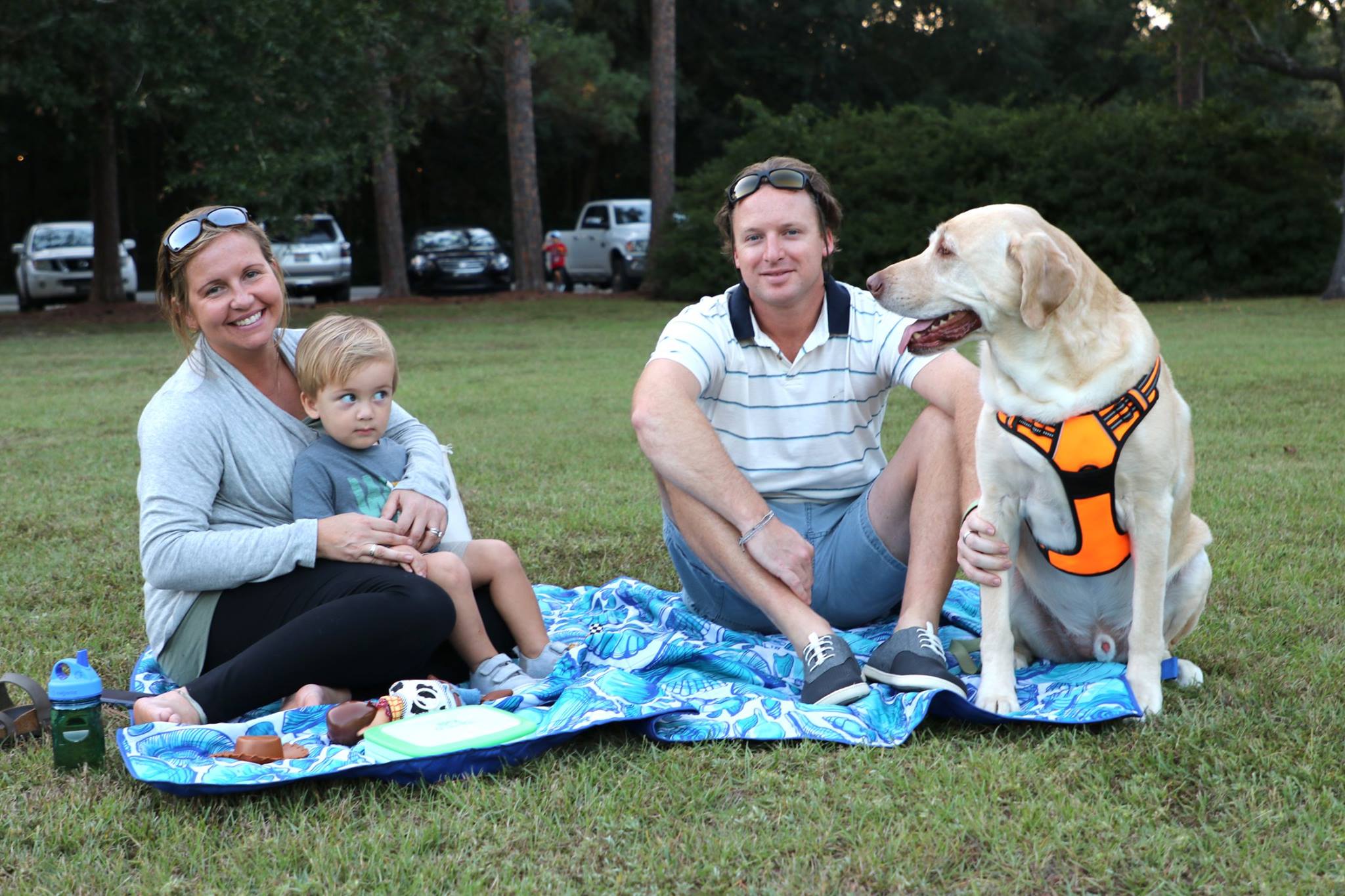 family sitting and smiling while they wait for the movie