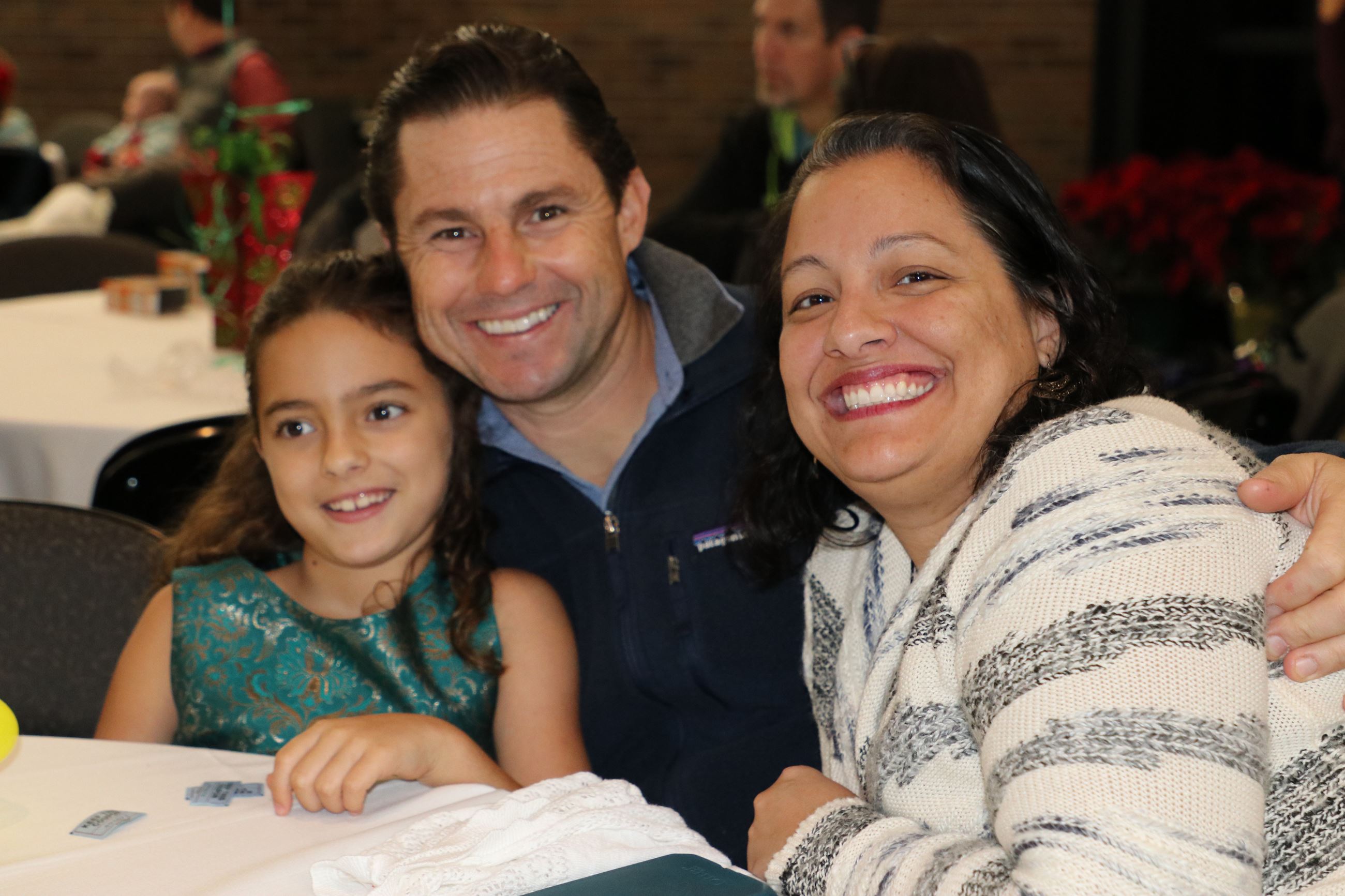 family smiling for photo