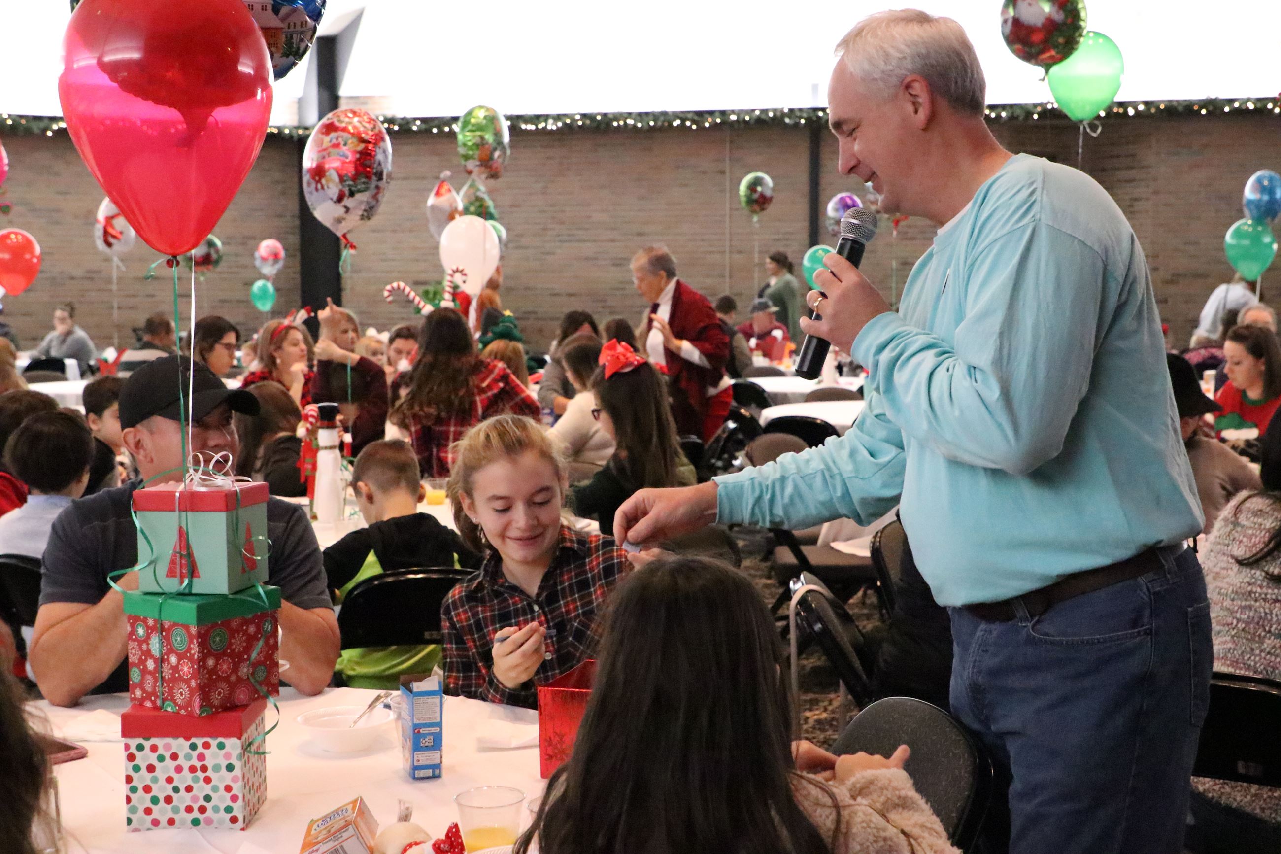 girl drawing names for prizes