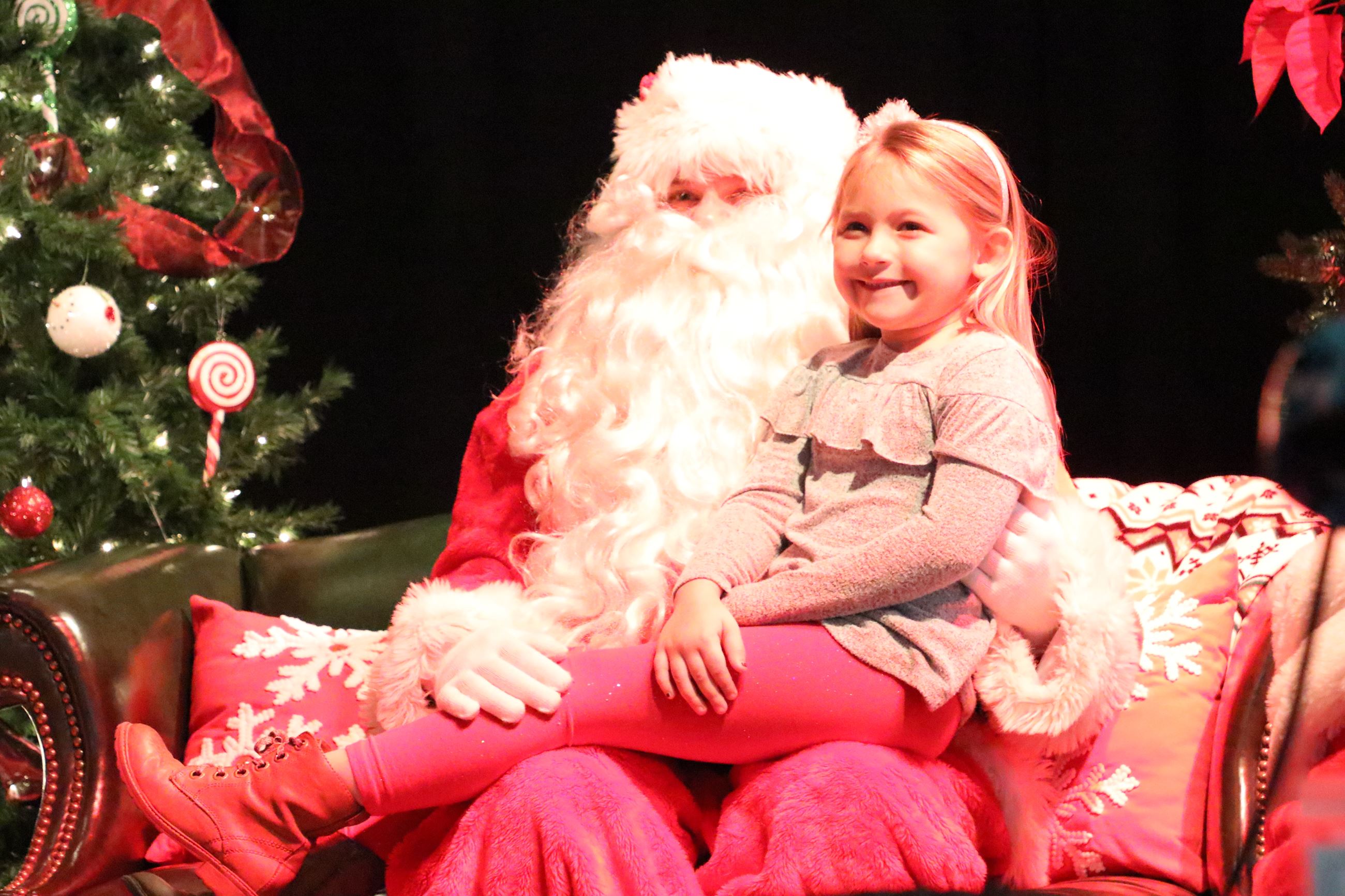 girl sitting on santa's lap