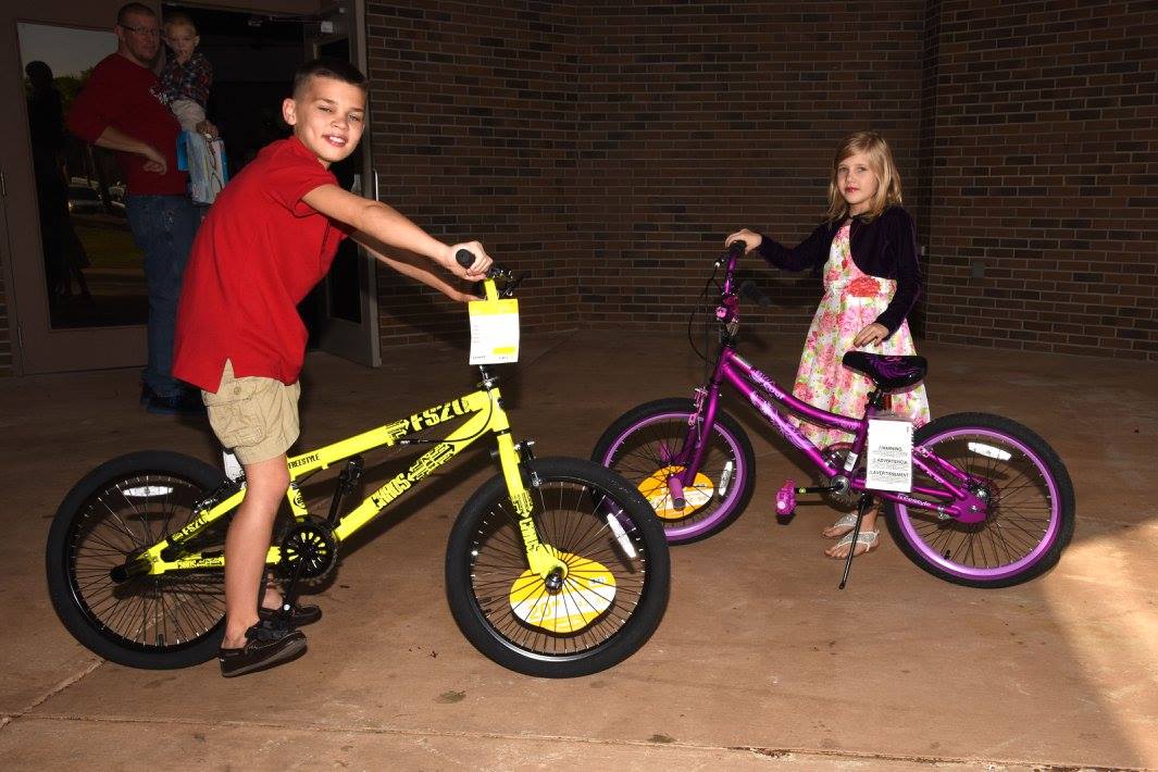two kids on new bicycles
