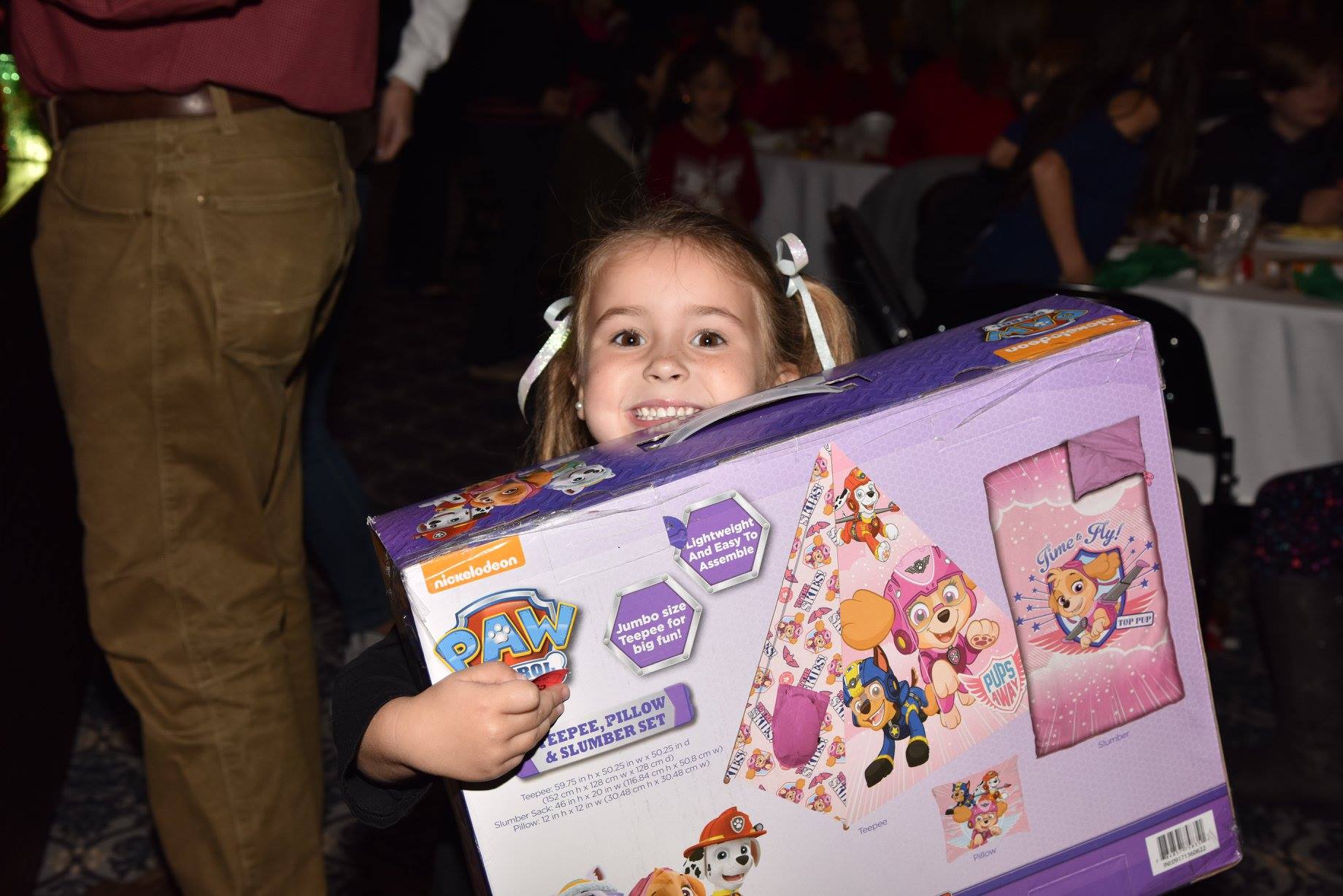 child holding up new toy