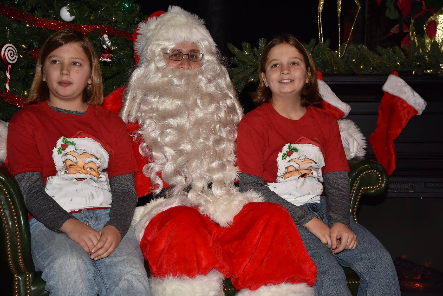 two girls sitting with Santa