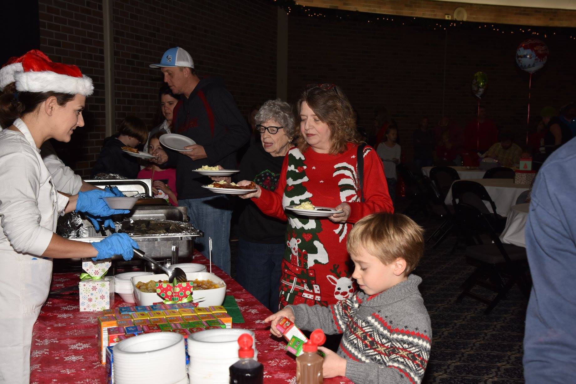 people getting food from buffet