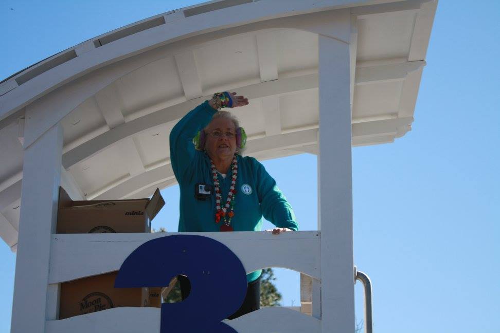 woman throwing beads