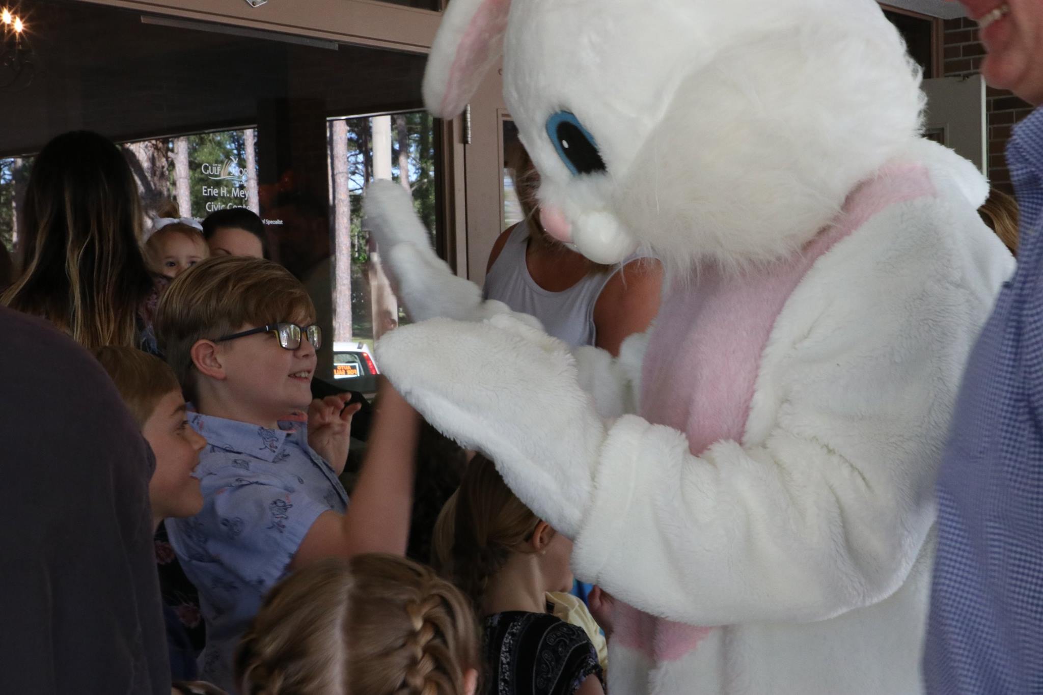 child high-fiving the Easter Bunny