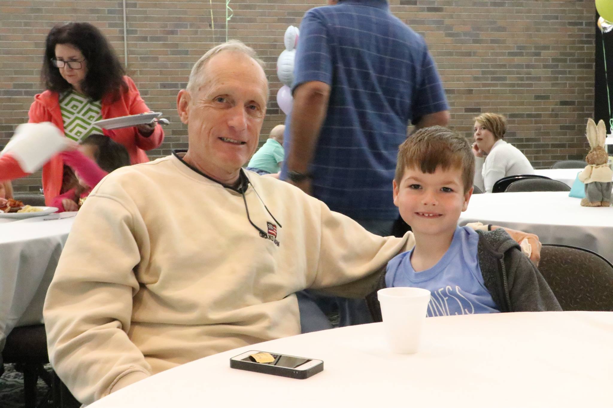 grandfather and grandson smiling